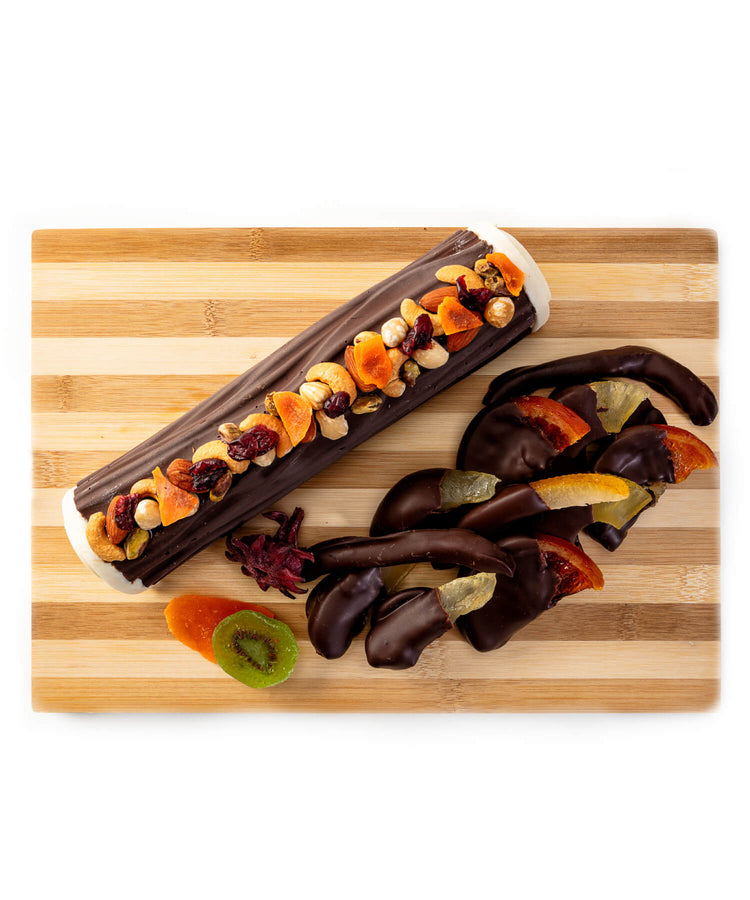 Praline Log topped with nuts and dried fruits surrounded with chocolate dipped glace fruits for Tu B'Shvat