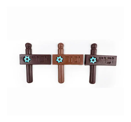 Solid choco Purim Groggers engraved with the word "Zachor" wrapped & tied with colorful ribbons